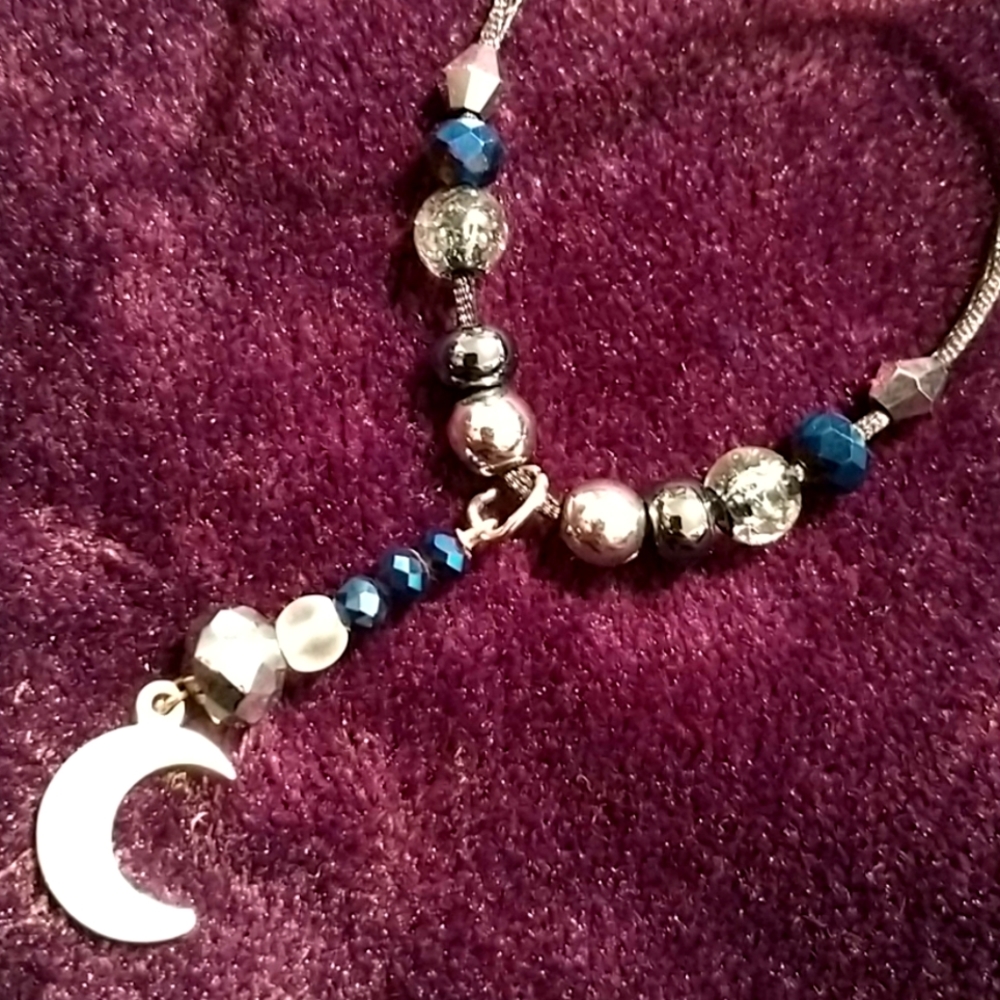 Sterling silver moon necklace with Crystals, glass, and metallic beads.